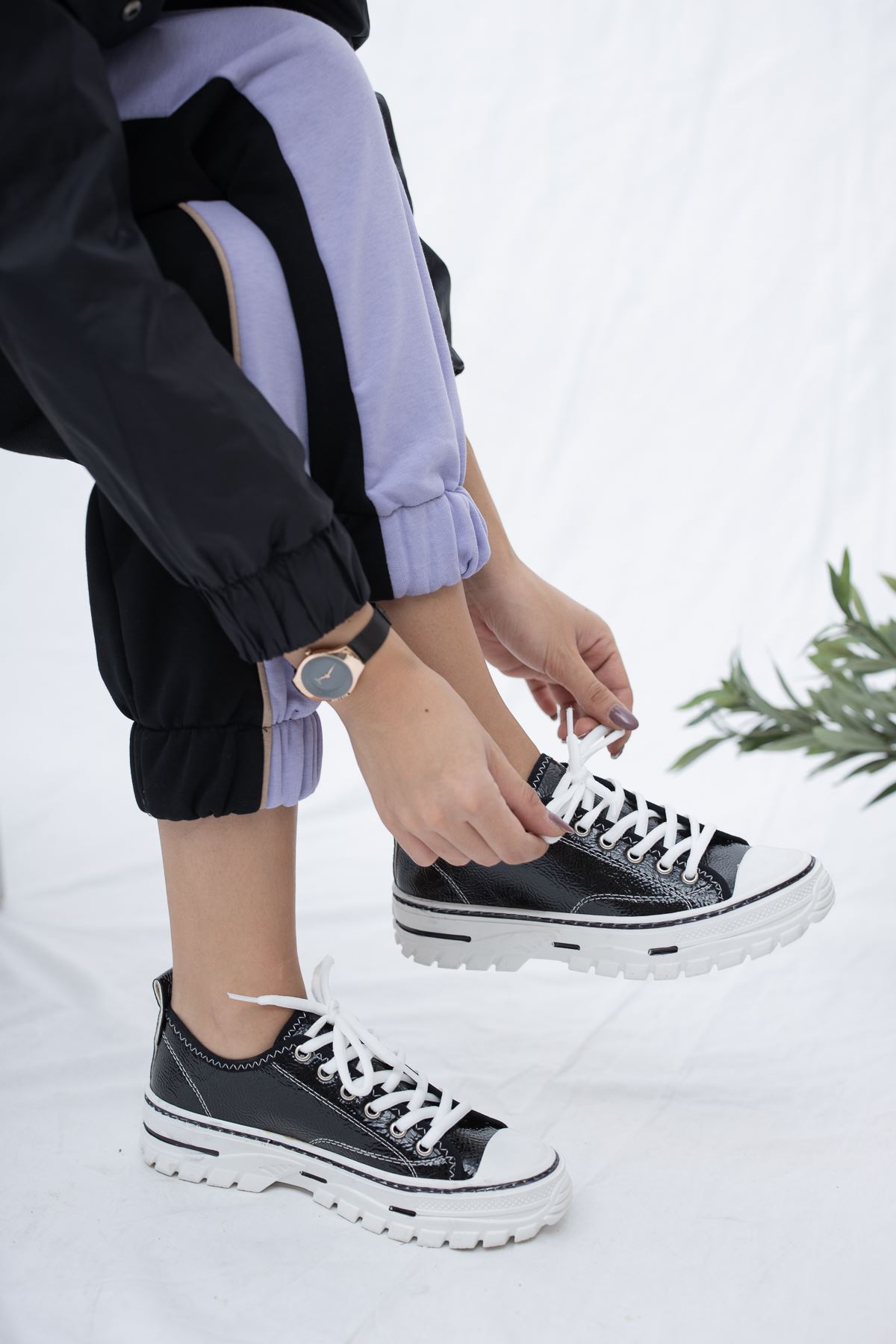 Black shiny leather sneakers with lace-up front